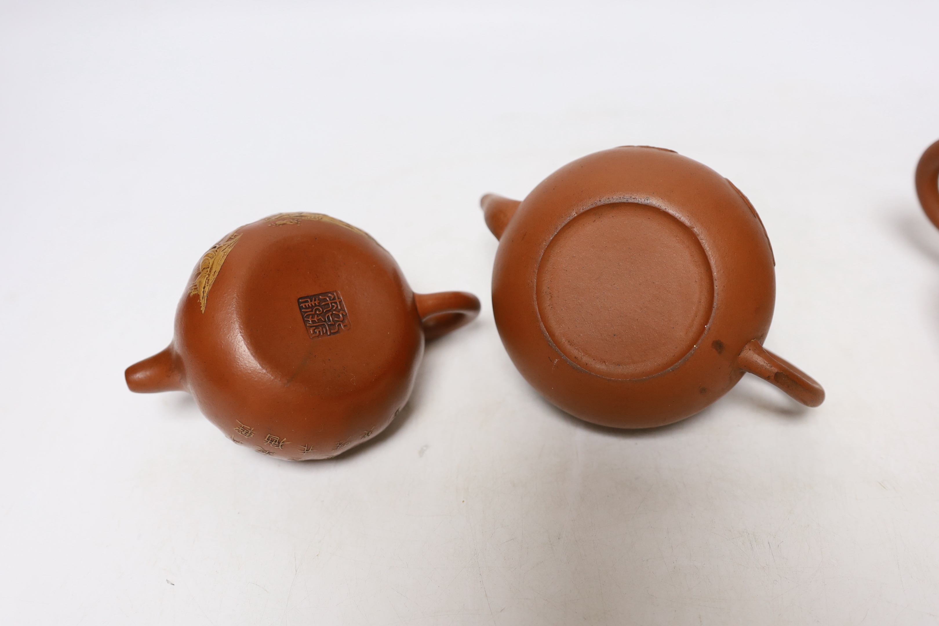 Four Chinese Yixing teapots, one slip decorated with a landscape, tallest 10.5cm
